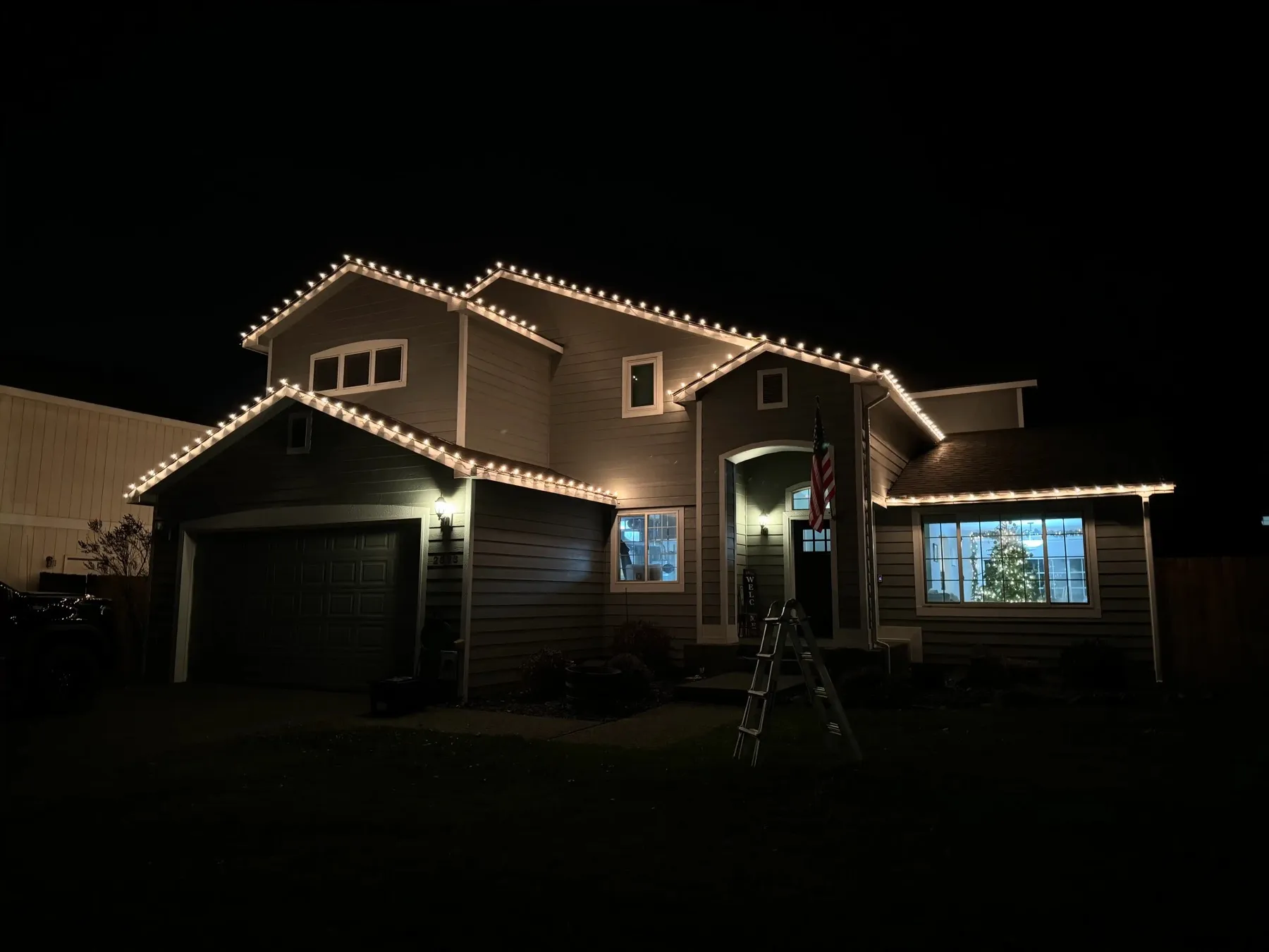 Two-story home with warm white C9 roofline lighting